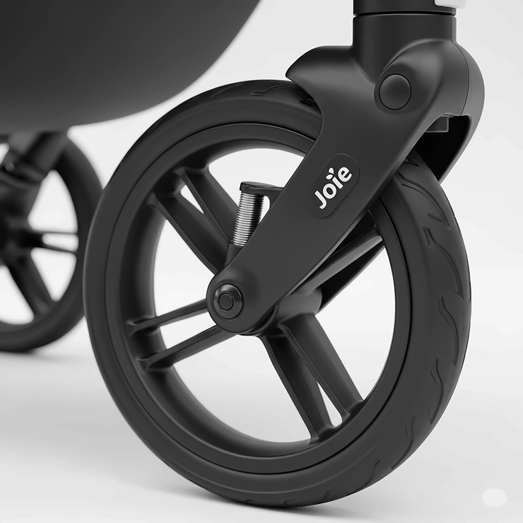 Detail shot of a durable wheel with advanced suspension on a Joie Versatrax pushchair, indicating a smooth ride for the baby.