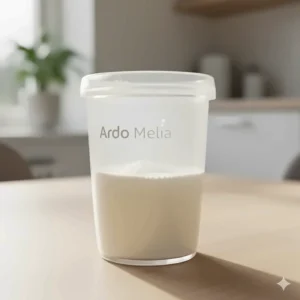 A full collection cup of breast milk from the Ardo Melia hands-free pump.