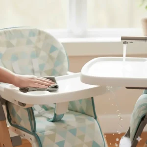 Close-up of the easy-to-clean, washable high chair pad and removable tray for quick cleanup.