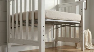 A high-resolution photorealistic close-up of the farmhouse 4-in-1 crib's interior, detailing the sturdy metal hardware and multiple adjustment holes that allow for three different mattress height settings.