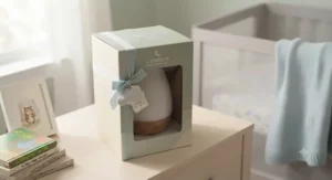 Smart LED nursery night light in its retail packaging box as a baby shower gift idea
