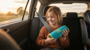 A young girl holding a colourful speaker playing audio books for kids road trips